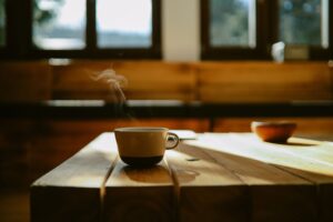 Warm-toned pour-over coffee on a natural wood table